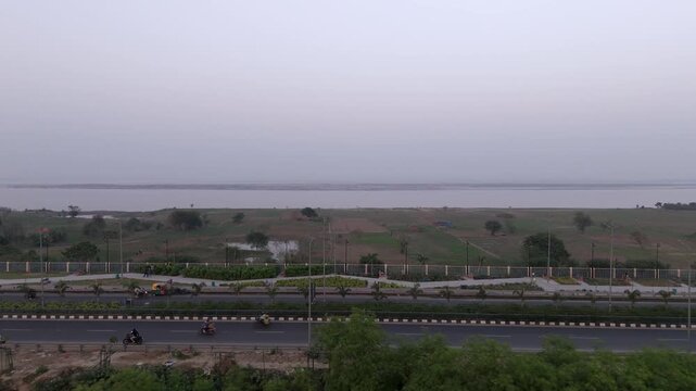 Agricultural fields near Ganga river basin reveals JP Ganga path expressway, Patna, Bihar, Drone shot