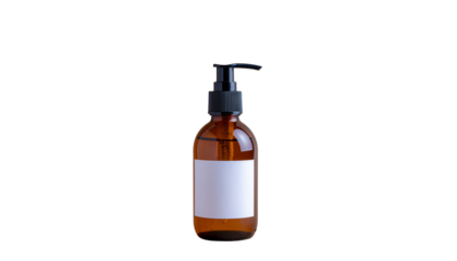 Amber glass bottle with black pump dispenser and blank white label on a white background studio shot product shot isolated