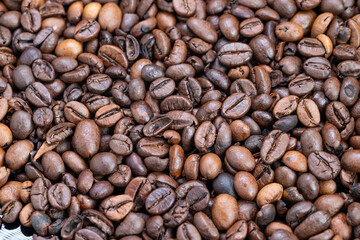 Photo of medium roasted beans under soft daylight with textured surface, Styling shot of fragrant roasted coffee beans illuminated by gentle morning sunlight highlighting texture