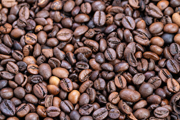 Coffee bean display, Artisan roasted Arabica coffee beans shown in detailed proximity image, Closeup shot illustrating rich texture of expertly roasted Arabica coffee beans