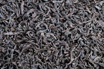 Closeup of tea, Sharp image highlighting structure and color of black tea leaves, Precise macro shot emphasizing textural details and hues of loose black tea strands