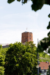 Beautiful city streets on a sunny summer day. Historic buildings among green trees in European city. 1 June 2025, Vilnius, Lithuania