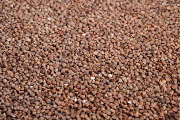 Raw buckwheat closeup, Close perspective highlighting buckwheat with textured background details, Macro shot capturing intricate textures and natural colors of buckwheat grains