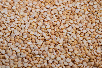 Yellow split peas in kitchen, Closeup of vibrant yellow split peas cooking, Detailed view of yellow split peas designed for comforting home cooked recipes and warm ambiance