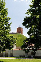 Beautiful city streets on a sunny summer day. Historic buildings among green trees in European city. 1 June 2025, Vilnius, Lithuania