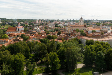 Beautiful city streets on a sunny summer day. Historic buildings among green trees in a European city. A panoramic view of the historic city from a bird's-eye perspective. June 1, 2025, Vilnius, Lithu