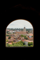 Historic buildings among green trees in a European city. A panoramic bird's-eye view of the historic city from the window of a tall old castle. June 1, 2025, Vilnius, Lithuania.