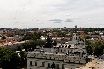 Beautiful city streets on a sunny summer day. Historic buildings among green trees in a European city. A panoramic view of the historic city from a bird's-eye perspective. June 1, 2025, Vilnius, Lithu
