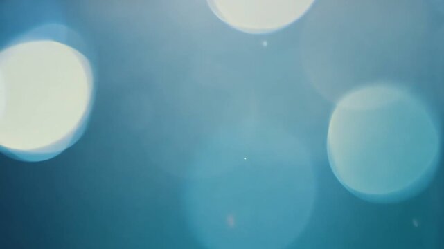 A serene and abstract background featuring soft blue tones and light bokeh effects, evoking a sense of calm and tranquility, perfect for various design projects.