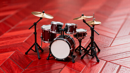 Miniature drum set on red floor