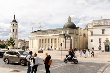 Beautiful city streets on a sunny summer day. Historic buildings among green trees in European city. 1 June 2025, Vilnius, Lithuania