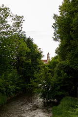 Beautiful city streets on a sunny summer day. Historic buildings among green trees in European city. 1 June 2025, Vilnius, Lithuania
