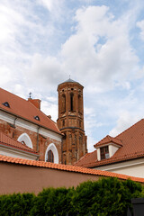 Beautiful city streets on a sunny summer day. Historic buildings among green trees in European city. 1 June 2025, Vilnius, Lithuania