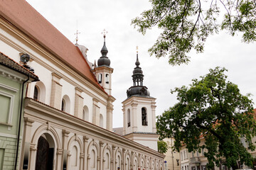 Beautiful city streets on a sunny summer day. Historic buildings among green trees in a European city. June 1, 2025, Vilnius, Lithuania.