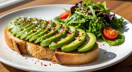 Delicious avocado toast with fresh green salad and cherry tomatoes on a white plate