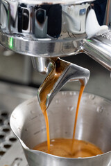Close-up shot of dual Spout Espresso Pour into Stainless Cup