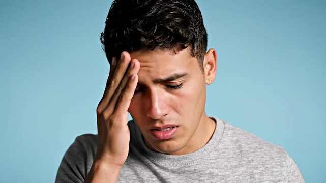 Man Experiencing Discomfort Portrait on Blue Background: Feeling Ill or Painful