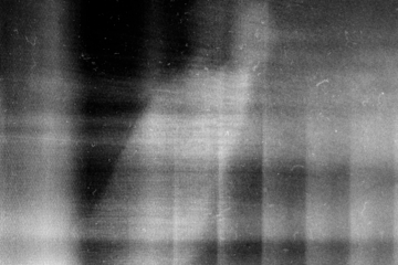 Stippled grain texture background. Black sprayed dots gradient wallpaper. Rough noisy sand dotted backdrop.