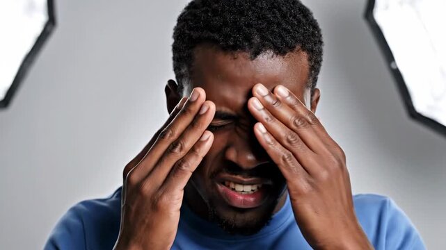 Man Experiencing Pain or Frustration in Studio: Diverse Emotions and Expressions