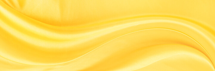 yellow gold satin texture that is white silver fabric luxurious shiny that is abstract silk cloth background with patterns soft waves blur beautiful.