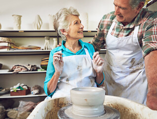 Pottery, workshop and senior couple with clay, creative and bonding with hobby, romance and together. Happy, elderly man and old woman with skills for craftsmanship, art process or people on date