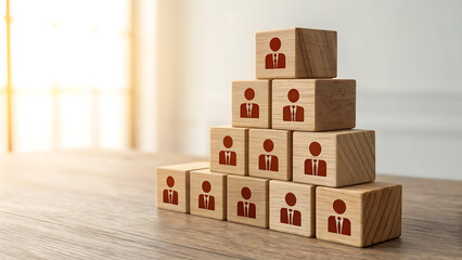 Wooden blocks arranged in a pyramid with human icons on them
