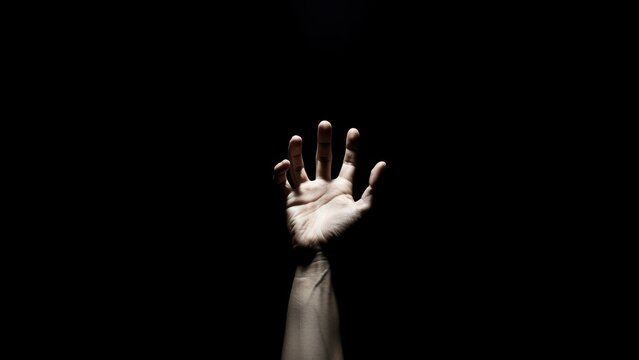 Outstretched hand reaching into darkness symbolizing hope and aspiration - Powered by Adobe