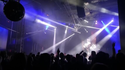 Energetic Nightclub Crowd Dancing Under Stage Lights and Disco Ball - Powered by Adobe