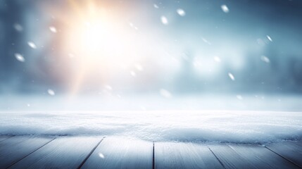 Winter scene with wooden surface snow falling and blurred trees background.