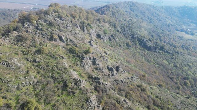 Aerial drone footage from Monte Ceva, Colli Euganei: rolling hills, volcanic peaks, forests and wide panoramic views. Ideal for nature, travel and landscape stock footage.