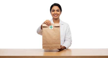 Pharmacist holds a medicine delivery bag over a wooden counter.