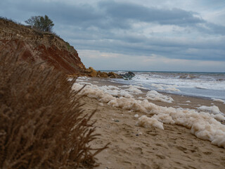 Red Clay Cliff Sea Foam Wild Beach