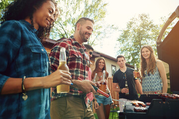 Fototapeta premium Friends, barbecue and people with meat, backyard and meal prep for party, happy and social gathering. Outdoor, cooking and group with alcohol for reunion, smile and together for bbq, event or house