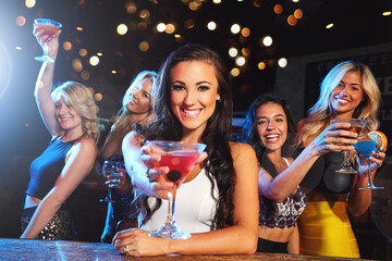 Happy women, portrait and friends with drink in nightclub for party, dancing event or celebration. Group, female people or smile with alcohol, cocktail or bokeh for nightlife, disco or new year