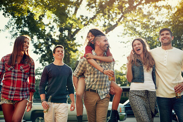 Walking, piggyback and friends in nature on holiday, getaway or weekend trip together for...