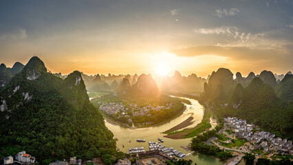 Aerial view of the winding river and mountain landscape at sunset in Guilin.