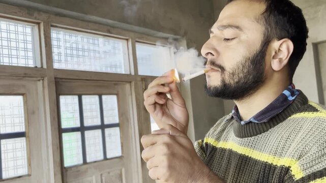 Young boy weed addictive man coughing while smoking a marijuana cigarette. Young boy coughing heavily while burning a cigarette or smoking a weed cigrette. Tobacco causes cancer concept. Stop smoking.