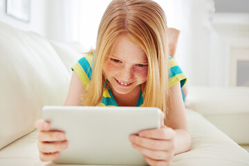 Home, girl and child with tablet, relax and smile with online comedy, entertainment and internet....