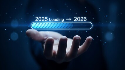 Hand holding a futuristic digital loading bar indicating the transition from the year 2025 to 2026 in a dark, technological environment symbolizing progress and future planning