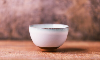 Traditional japanese ceramic on rustic wooden background. Soft focus. Copy space.	