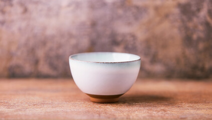 Traditional japanese ceramic on rustic wooden background. Soft focus. Copy space.	