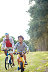 Happy, dad and son outdoor with bicycle for learning, childhood memories and bonding together....
