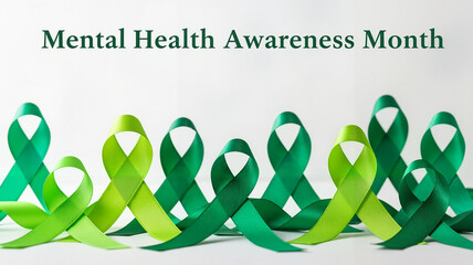 Collection of green ribbons for Mental Health Awareness Month on a soft background