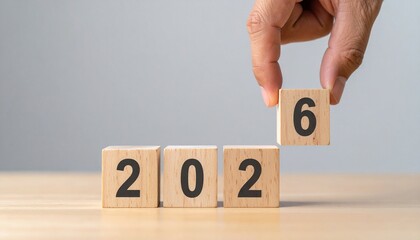 Hand flipping wooden block to change year.