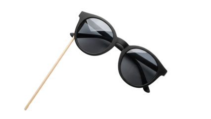 Black round sunglasses on a stick isolated PNG, fun party prop for photo booth and costume accessories, on transparent background