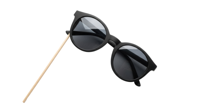 Black round sunglasses on a stick isolated PNG, fun party prop for photo booth and costume accessories, on transparent background