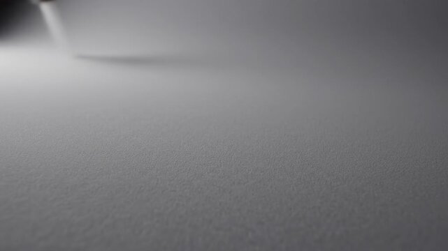 Slow continuous subtle movement across a perfectly smooth matte gray texture surface creating an infinite empty void background background, soft light, subtle movement