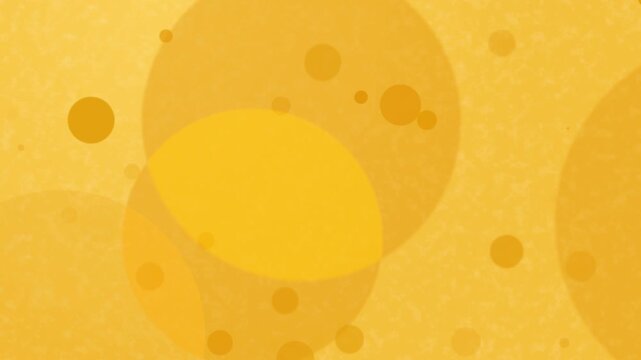 A yellow background with various sized circles giving a bubbly or spongelike texture