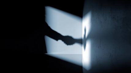 Shadow of handshaking symbolizes collaboration and agreement, illuminated by a spotlight against a dark background