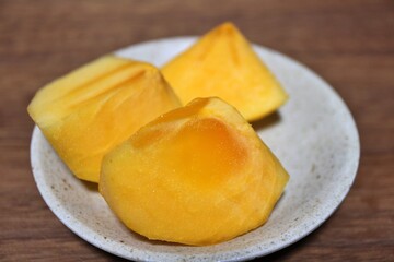 Fresh kaki persimmon fruits purchased at a supermarket in Tokyo, Japan